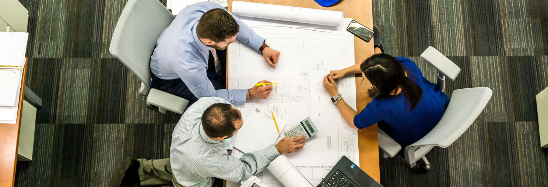 Three coworkers collaborating at a table